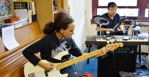 Student playing guitar